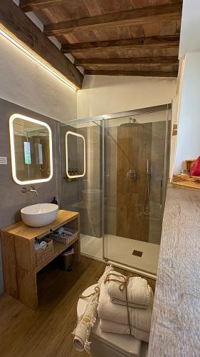 a bathroom with a shower and a sink and a sink at Bouganville in Rosignano Marittimo