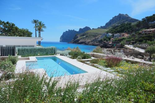 a villa with a swimming pool and a view of the ocean at El Vicenç de la Mar - Adults Only - Over 12 in Pollença