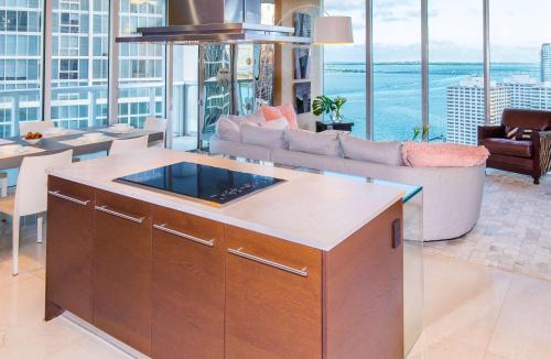 a kitchen with an island in a living room at MVR - Oceanfront Corner Balcony Luxe SPA in Miami