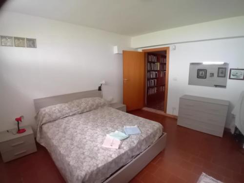 a bedroom with a bed with two papers on it at Carachouse Pellaro in Pellaro