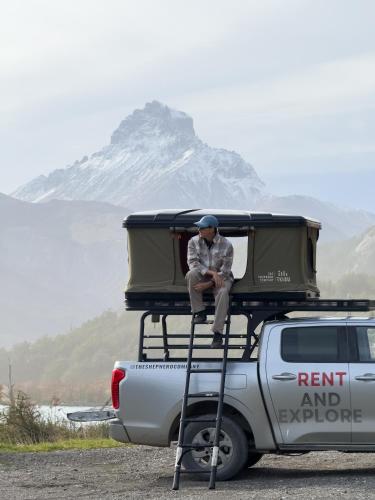 a man sitting on top of the back of a truck at Camper camioneta equipada cajon del maipo in San José de Maipo