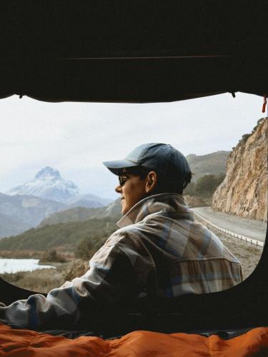 a man sitting in a truck looking out a window at Camper camioneta equipada cajon del maipo in San José de Maipo