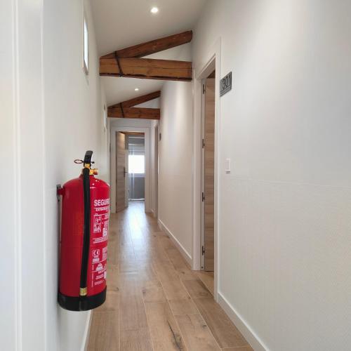 a red fire hydrant is on the wall of a hallway at Hostalito del Cuéntame Auto check-in in Burgos