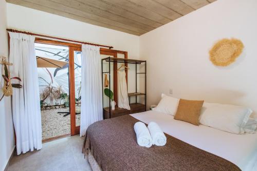 a bedroom with a bed with two white pillows on it at Smart Hotel Reserva Ilhabela in Ilhabela