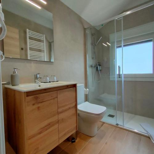 a bathroom with a sink and a toilet and a shower at Hostalito del Cuéntame Auto check-in in Burgos