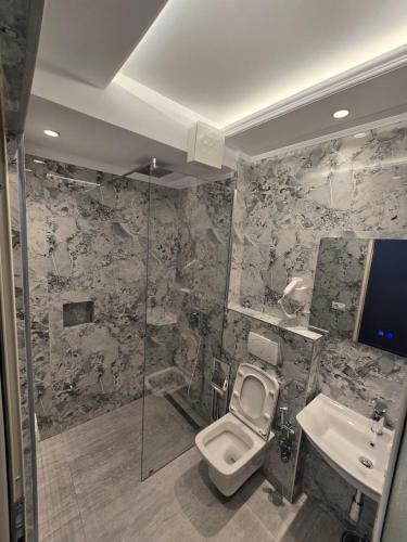 a bathroom with a toilet and a sink at Hotel Belvedere in Pogradec