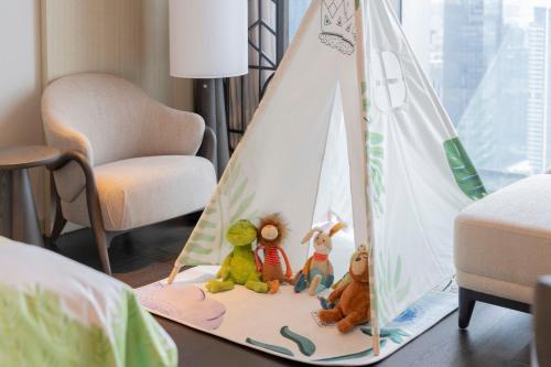 a group of toy figurines sitting in a play tent at The St. Regis Shenzhen Bao'an in Shenzhen