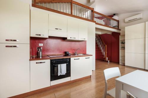 a kitchen with white cabinets and a staircase at view of the Arno Perla sull'Arno IX in Florence