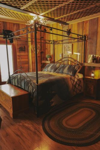 a bedroom with a bed in a room with wooden walls at Cascade Sunset House - Crater Lake Adventures! in Eagle Point