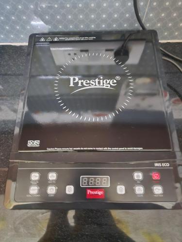 a device with the word prestige on the side of it at Sri Sakthi Home Stay - Beyond the Expectations - We maintain standards in Tirupati