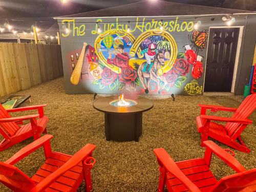 a room with chairs and a table and a sign at The Lucky Horseshoe 4BR Derby Side Retreat in Louisville
