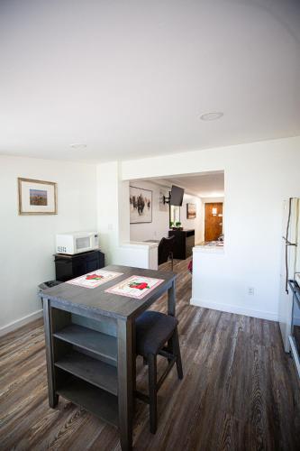 a living room with a wooden table and a living room at Riverwood Resort on the Gunnison in Delta