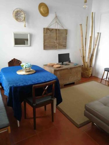 a living room with a blue table and a desk at GuestReady - Cheerful Ponta Delgada townhouse in Ponta Delgada