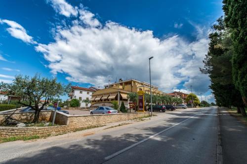 a street with a building on the side of the road at Vilola in Umag