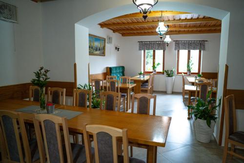 a dining room with a table and chairs at Penzión Zvala in Pichne