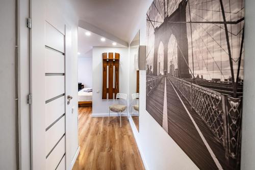 a hallway with a wall mural of a bridge at Hugo apartment in Šiauliai