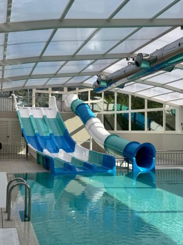 a water slide in a swimming pool at Augusta Eco Wellness Resort 4 Superior in Sanxenxo