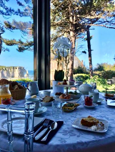 a table with a blue table cloth with food on it at Chante Brise B&B in Étretat