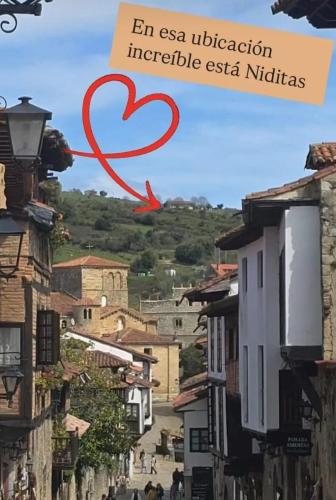 a red heart in the sky over a city at Niditas Suites & Horses in Santillana del Mar