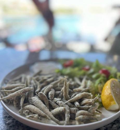 a plate of food on a table with vegetables at Studio apartments Kali in Kali