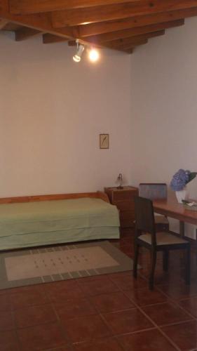 a bedroom with a bed and a desk and a chair at GuestReady - Azores City Loft in Ponta Delgada