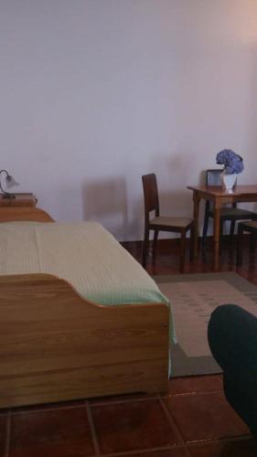 a bedroom with a bed and a table and chairs at GuestReady - Azores City Loft in Ponta Delgada