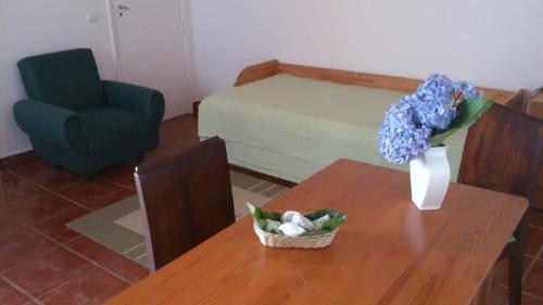 a table with a vase of flowers on top of it at GuestReady - Azores City Loft in Ponta Delgada