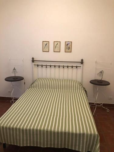 a bedroom with a bed with two tables on it at GuestReady - Ponta Delgada city house in Ponta Delgada