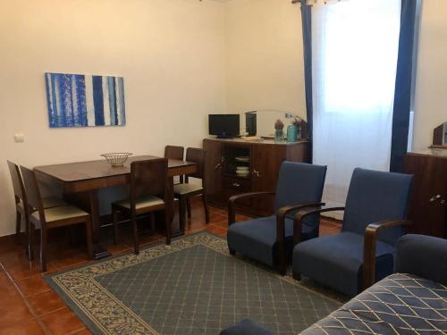 a living room with a dining room table and chairs at GuestReady - Ponta Delgada city house in Ponta Delgada