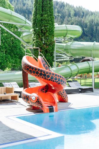a slide in a water park with a swimming pool at Familienhotel Trebesingerhof in Trebesing