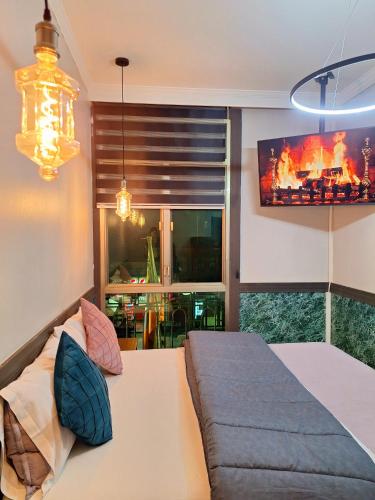 a living room with a bed and a tv at Hotel Asturias in Viña del Mar