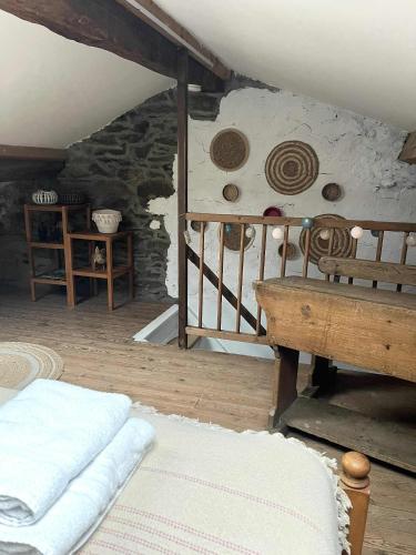 a room with a bed and a stone oven at Au Fil de boh'Ô in Vresse-sur-Semois