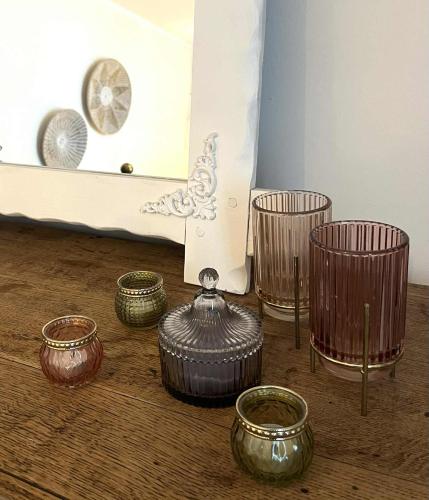 a group of bowls sitting on the floor in front of a mirror at Au Fil de boh'Ô in Vresse-sur-Semois