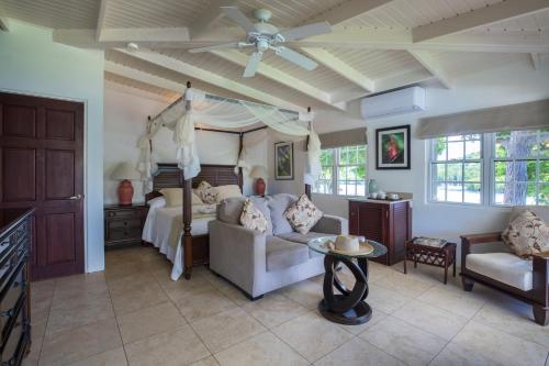 a bedroom with a bed and a ceiling fan at Gunpowder House & Suites in English Harbour Town