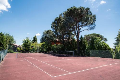 a tennis court with a tennis racket on it at Villa Solzago - by MyHomeInComo in Tavernerio