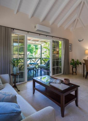 a living room with a couch and a coffee table at Gunpowder House & Suites in English Harbour Town