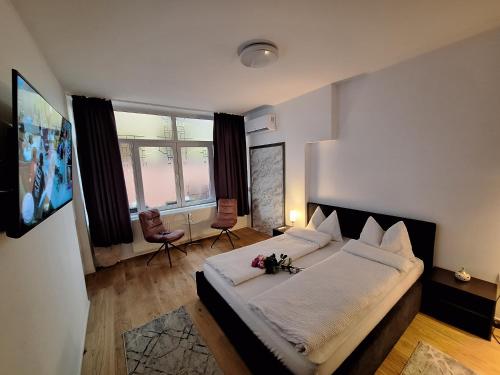 a bedroom with a large bed and a large window at Ana's Garden Sibiu in Sibiu