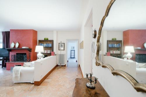 a living room with a large mirror on the wall at Villa Solzago - by MyHomeInComo in Tavernerio