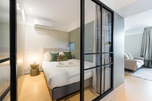 a bedroom with a bed and a living room at GuestReady - Graceful stay in Matosinhos in Matosinhos