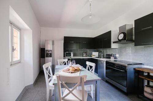 a kitchen with a table and chairs in a kitchen at Villa Solzago - by MyHomeInComo in Tavernerio