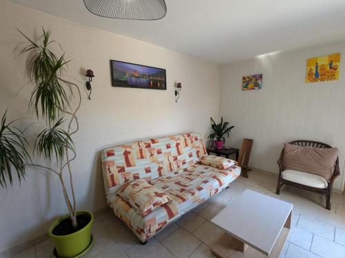 a living room with a couch and a table at Appartement indépendant à Saran, proche Orléans - FR-1-590-574 in Saran