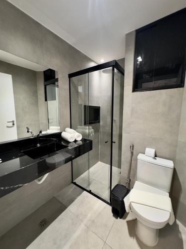 a bathroom with a toilet and a shower and a sink at Las Brisas Beach Hotel in Natal