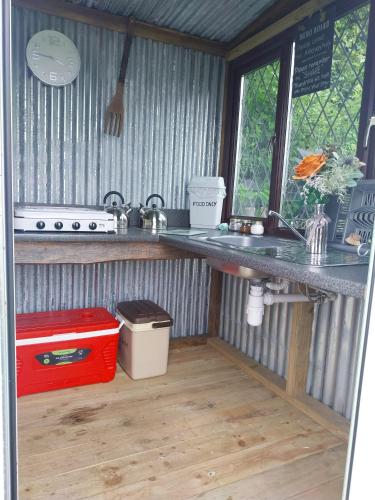 a kitchen with a counter and a sink at Hendre Glamping Retreat, The Rabbit Warren in Clydey