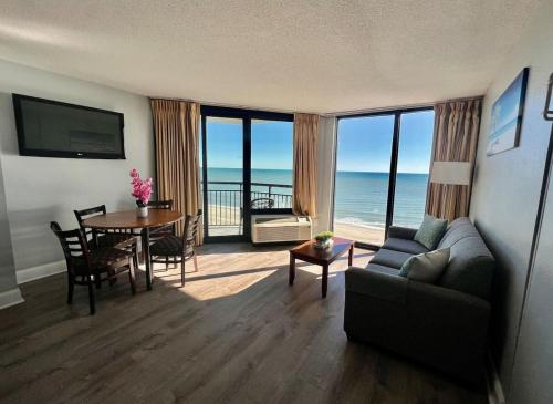 a living room with a couch and a table at Gorgeous Oceanfront Suite! 1Br Condo, Dog friendly! 706 in Myrtle Beach