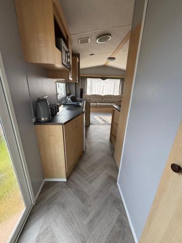 an interior view of a kitchen in an rv at Beautiful 2 bedroom caravan , Leysdown in Leysdown-on-Sea
