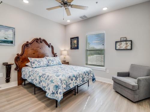 a bedroom with a bed and a chair at Nauta Mirage in Rockport