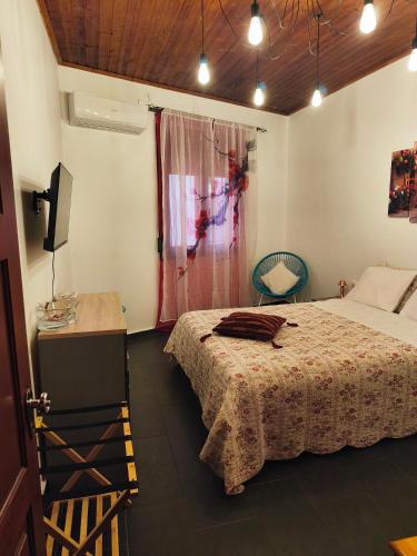 a bedroom with a bed and a table and a television at Anastasia's Corner in Petra