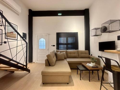 a living room with a couch and a table at Astera Luxury Loft in Ofrínion