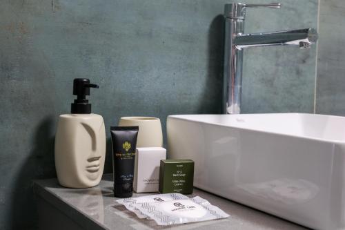 a bathroom with a sink and toiletries on a counter at Heroes Apartment Esztergom in Esztergom