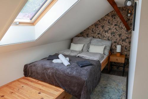 a bedroom with a bed in a attic at Heroes Apartment Esztergom in Esztergom